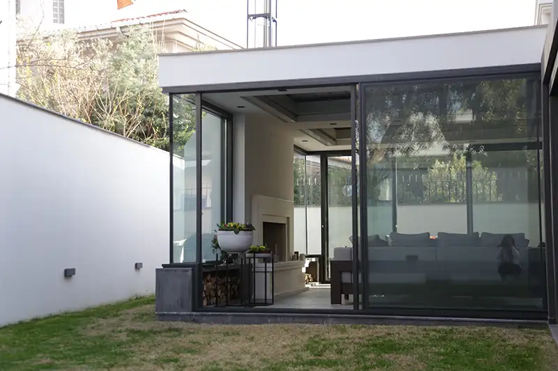Bora sliding glass panel system attached to house