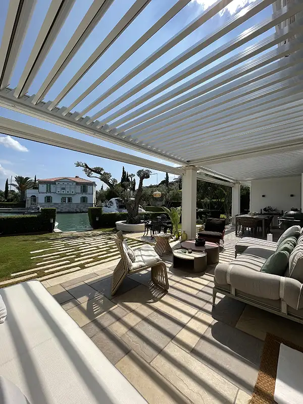 attached backyard SkyCloud pergola system with opened roof panels to allow sunlight